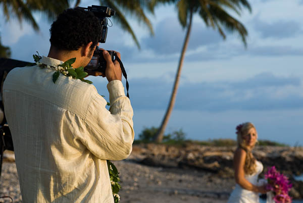 Groom taking picture of bride