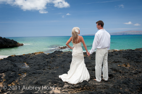 blue water and bride and groom at makena cove